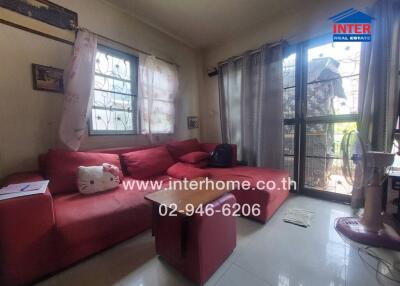 Cozy living room with red sectional sofa and natural light