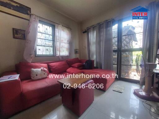 Cozy living room with red sectional sofa and natural light