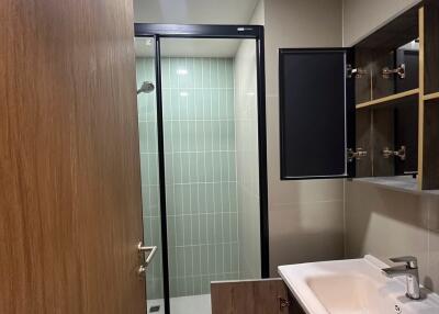 Modern bathroom with a glass shower enclosure and vanity sink.