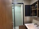 Modern bathroom with a glass shower enclosure and vanity sink.