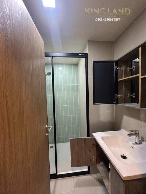 Modern bathroom with a glass shower enclosure and vanity sink.