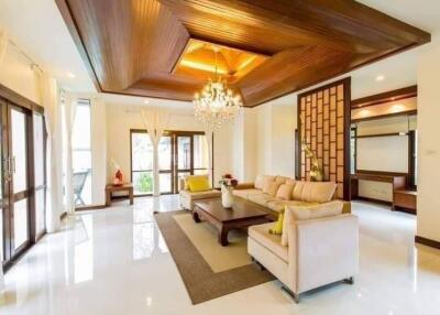 Modern living room with chandelier and wooden ceiling design