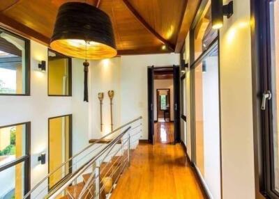 Spacious hallway with wooden flooring and large windows