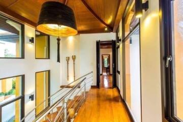 Spacious hallway with wooden flooring and large windows