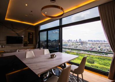 Modern dining area with large windows overlooking city skyline