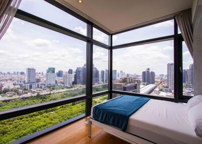 Bedroom with floor-to-ceiling windows and city view