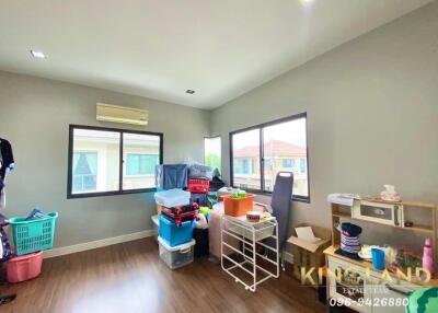 Well-lit bedroom with air conditioner and storage boxes