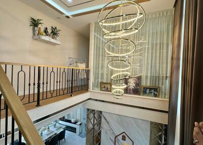 Modern living room with a unique chandelier and mezzanine