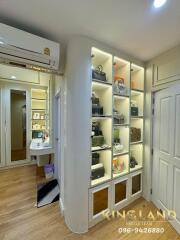 Spacious closet with illuminated shelves and storage space