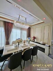 Elegant dining room with a chandelier and modern furnishings