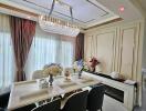 Elegant dining room with a chandelier and modern furnishings