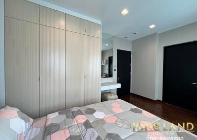 Spacious and modern bedroom with large closet and comfortable bed