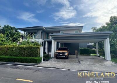 Modern two-story house with garden and carport