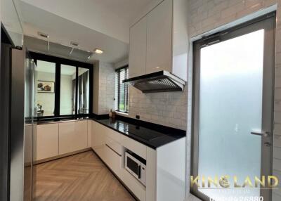 Modern kitchen with white cabinets and black countertop