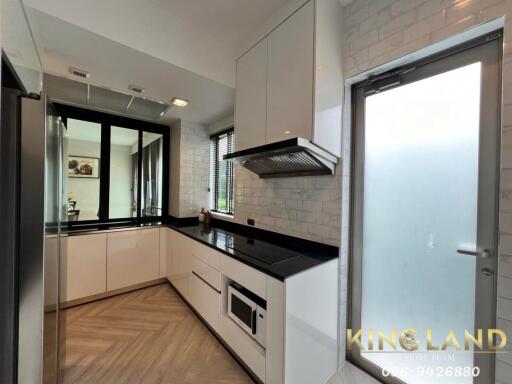 Modern kitchen with white cabinets and black countertop