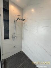 Modern bathroom with marble walls and rain shower system