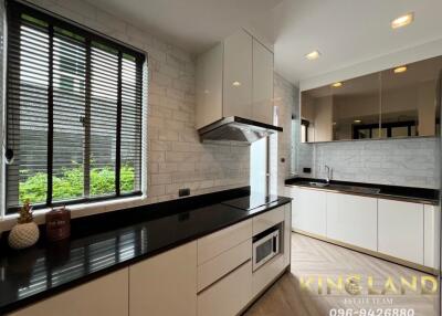 Modern kitchen with black countertops and white cabinets