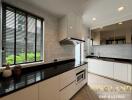 Modern kitchen with black countertops and white cabinets