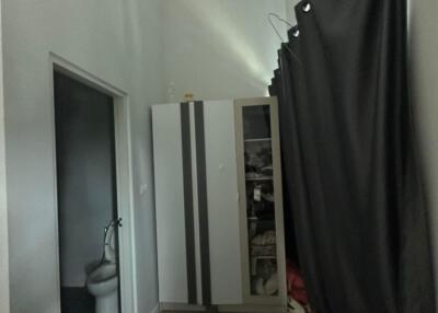 Small bedroom with wardrobe and curtain partition