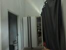 Small bedroom with wardrobe and curtain partition