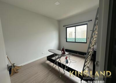 Minimalist bedroom with ironing board and window