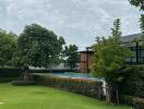 Outdoor area with a pool and manicured lawn