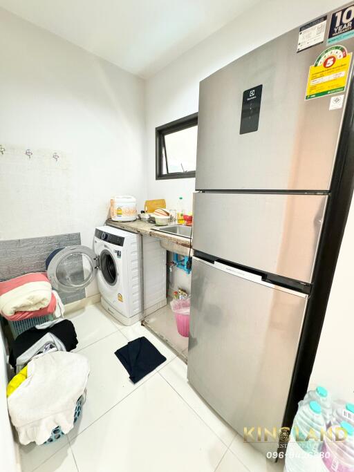 Laundry area with appliances and storage space