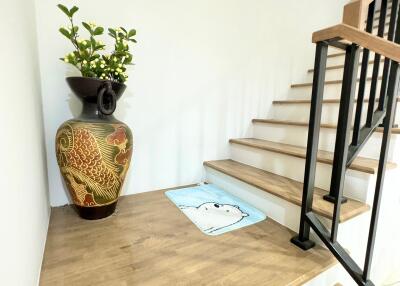 Decorative stairway with wooden steps and metal railing