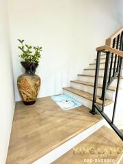 Decorative stairway with wooden steps and metal railing