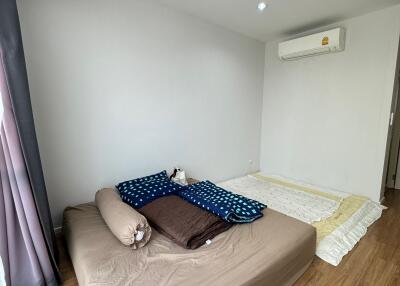 Simple bedroom with two beds and an air conditioner