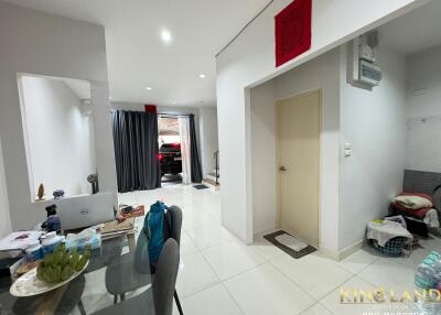 Modern living space with dining area and view towards front door and garage