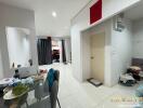 Modern living space with dining area and view towards front door and garage