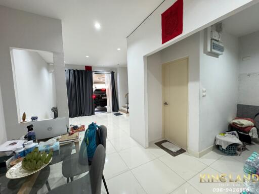 Modern living space with dining area and view towards front door and garage