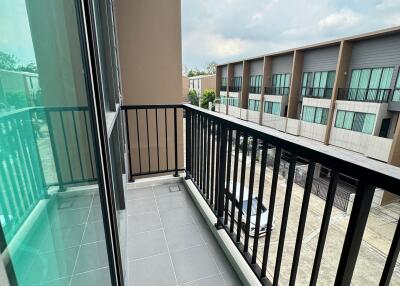 Modern balcony with railing and view of neighboring buildings