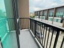 Modern balcony with railing and view of neighboring buildings