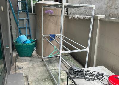 Outdoor utility space with storage and drying rack