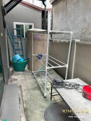 Outdoor utility space with storage and drying rack