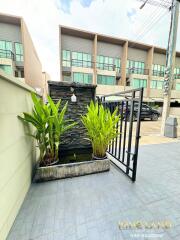 Outdoor area with gate and water feature