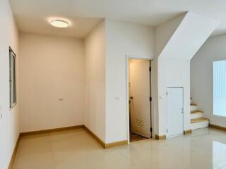 Small room with a window and a door under stairwell