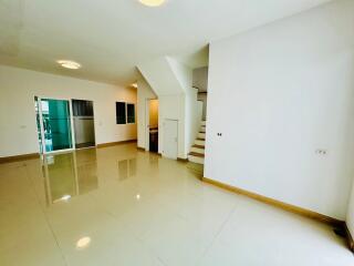 Spacious living room with staircase