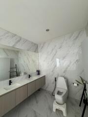 Modern bathroom with dual sink vanity and toilet