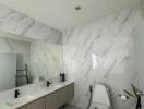 Modern bathroom with dual sink vanity and toilet