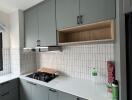 Modern kitchen with grey cabinets and white countertop