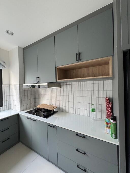 Modern kitchen with grey cabinets and white countertop