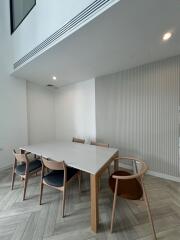 Modern dining area with wooden table and chairs