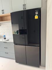 Modern kitchen with black refrigerator