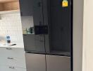 Modern kitchen with black refrigerator