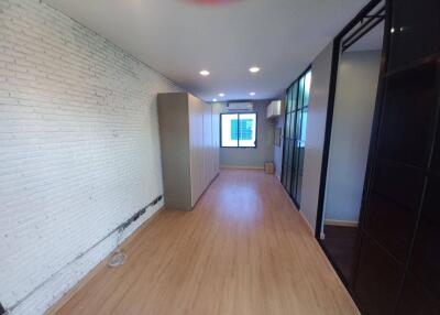 Spacious bedroom with wooden flooring and wardrobe