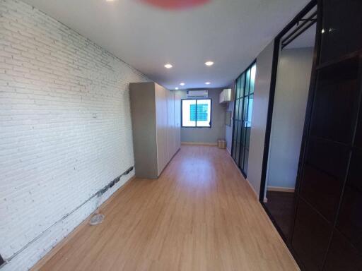 Spacious bedroom with wooden flooring and wardrobe