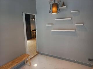 Minimalist entryway with shelving and wooden bench